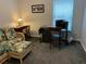 Cozy office space with traditional wood desk, rolling chair, and a floral patterned couch at 3808 Tupelo Branch Row, Mount Pleasant, SC 29429