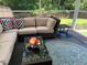 Relaxing screened patio with comfortable wicker furniture and stylish patterned pillows at 3808 Tupelo Branch Row, Mount Pleasant, SC 29429