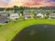 Aerial view of homes and a pond in a well-planned community, perfect for tranquil living at 438 Flat Rock Ln, Summerville, SC 29486