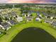 Aerial view of homes surrounding a pond in a well-planned community at 438 Flat Rock Ln, Summerville, SC 29486