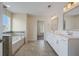 Bright bathroom featuring double sinks, white cabinets, and a bathtub at 438 Flat Rock Ln, Summerville, SC 29486
