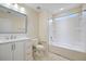 Bright bathroom with white vanity, framed mirror, and tiled floor around the tub and shower at 438 Flat Rock Ln, Summerville, SC 29486