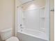 Clean bathroom featuring a shower over the tub with tiled walls and a white toilet at 438 Flat Rock Ln, Summerville, SC 29486