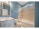 Cozy bathroom with a tiled shower-tub combination, light blue walls, and a white vanity at 438 Flat Rock Ln, Summerville, SC 29486