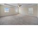 Spacious carpeted bedroom featuring three windows and a ceiling fan at 438 Flat Rock Ln, Summerville, SC 29486