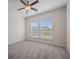 Bright bedroom with neutral walls, plush carpet, a ceiling fan, and two windows providing natural light at 438 Flat Rock Ln, Summerville, SC 29486