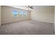 Spacious carpeted bedroom with a ceiling fan and three windows overlooking a serene outdoor view at 438 Flat Rock Ln, Summerville, SC 29486