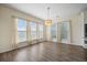 A dining room with a light fixture, wood floors, and windows with natural light at 438 Flat Rock Ln, Summerville, SC 29486