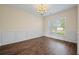 Empty dining room with laminate flooring, wainscoting, and natural light at 438 Flat Rock Ln, Summerville, SC 29486