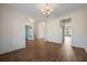 Bright dining area featuring hardwood floors, wainscoting and modern chandelier, ideal for Gathering meals and entertaining at 438 Flat Rock Ln, Summerville, SC 29486