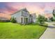 Charming two-story home with landscaped yard, a well-manicured lawn, and a welcoming front porch at 438 Flat Rock Ln, Summerville, SC 29486