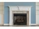 Close up of a fireplace with white mantle, tile surround, and built in bookshelves at 438 Flat Rock Ln, Summerville, SC 29486
