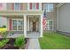 Inviting front porch with detailed columns and an American flag at 438 Flat Rock Ln, Summerville, SC 29486