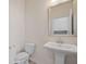 Elegant half bath featuring a pedestal sink and decorative mirror, complemented by neutral tones at 438 Flat Rock Ln, Summerville, SC 29486