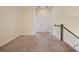 Upstairs hallway with neutral carpet, white doors, and a dark wooden railing leading to the staircase at 438 Flat Rock Ln, Summerville, SC 29486