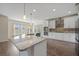 Modern kitchen with granite countertops, island sink, and stainless-steel appliances, creating a chef's dream space at 438 Flat Rock Ln, Summerville, SC 29486