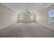 Large main bedroom with neutral carpet, a tray ceiling, ceiling fan, and three windows for ample light at 438 Flat Rock Ln, Summerville, SC 29486