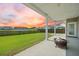 Backyard patio area featuring a fire pit, lush lawn, and a view of the serene pond at 438 Flat Rock Ln, Summerville, SC 29486