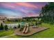 Community playground view with slides and swings and a pool in the background at 438 Flat Rock Ln, Summerville, SC 29486