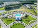 An aerial view of a Primary-planned community featuring a pool, playground, lakes, and golf cart paths at 4407 Palm Shadow Dr, Summerville, SC 29485