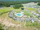 Aerial view showcasing community pool, amenity center, playground, walking paths and neighborhood at 4407 Palm Shadow Dr, Summerville, SC 29485