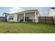 Beautiful backyard featuring a covered patio, lush green lawn, and a well-maintained privacy fence at 4407 Palm Shadow Dr, Summerville, SC 29485