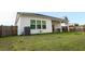 Spacious backyard featuring a well-manicured lawn, exterior view of the home and a cozy patio area at 4407 Palm Shadow Dr, Summerville, SC 29485