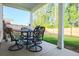 Spacious covered patio with wrought iron table and chairs, perfect for enjoying the outdoor backyard view at 4407 Palm Shadow Dr, Summerville, SC 29485