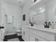 Bathroom featuring double sinks, black floor tiles, and modern fixtures at 4407 Palm Shadow Dr, Summerville, SC 29485