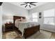 The bedroom features a wooden bed, decorative pillows, two windows and carpet at 4407 Palm Shadow Dr, Summerville, SC 29485