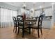 Charming dining room with a chandelier, a round table, seating for six, and white kitchen at 4407 Palm Shadow Dr, Summerville, SC 29485