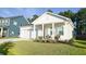 Charming home boasting a covered front porch, pristine lawn, and attached garage in a desirable neighborhood at 4407 Palm Shadow Dr, Summerville, SC 29485