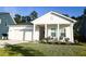 Charming home featuring a welcoming front porch, well-maintained lawn, and inviting curb appeal on a sunny day at 4407 Palm Shadow Dr, Summerville, SC 29485