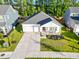 Well-maintained home with a two-car garage, manicured lawn, and inviting front porch at 4407 Palm Shadow Dr, Summerville, SC 29485