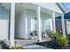 Inviting front porch with stylish seating and well-manicured landscaping adds curb appeal to this charming home at 4407 Palm Shadow Dr, Summerville, SC 29485