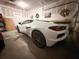 Neat garage featuring a white sports car and golf cart, providing secure parking and additional storage solutions at 4407 Palm Shadow Dr, Summerville, SC 29485