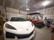 Spacious garage featuring a white sports car, golf cart, and ample storage space with modern lighting at 4407 Palm Shadow Dr, Summerville, SC 29485