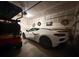 Well-organized garage with a white sports car, golf cart, and ample space for parking and storage at 4407 Palm Shadow Dr, Summerville, SC 29485