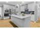 Kitchen features stainless steel appliances, white cabinets, an island, and wood floors at 4407 Palm Shadow Dr, Summerville, SC 29485