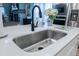 This kitchen features a stainless steel sink and black faucet with white countertops at 4407 Palm Shadow Dr, Summerville, SC 29485