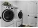 Well-equipped laundry room with modern washer and dryer, ample storage, and a clean, functional layout at 4407 Palm Shadow Dr, Summerville, SC 29485