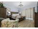 Comfortable main bedroom with a wooden bed frame, chandelier, and neutral decor at 4407 Palm Shadow Dr, Summerville, SC 29485