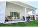 Covered patio featuring a sliding glass door, outdoor grill, and a comfortable seating area at 4407 Palm Shadow Dr, Summerville, SC 29485