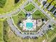 Aerial view of community pool showcasing seating, playground, landscaping, buildings, and parking at 4407 Palm Shadow Dr, Summerville, SC 29485