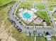 Aerial view of a community pool featuring lounge chairs, landscaping, playground, and ample parking at 4407 Palm Shadow Dr, Summerville, SC 29485