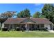 Charming single story brick home with covered porch, flower garden, attached garage and well manicured lawn at 4504 Winterwood Pl, Ladson, SC 29456