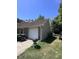 Side exterior view of garage and driveway, showing lawn area and grilling area at 4504 Winterwood Pl, Ladson, SC 29456