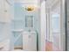 Bright bathroom featuring a white vanity, shelving, mirror, and a shower, creating a fresh space at 4767 June St, North Charleston, SC 29405