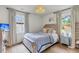 Brightly lit bedroom features two windows, hardwood floors, and neutral color palette at 5028 Victoria Ave, North Charleston, SC 29405