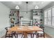 Inviting dining room featuring a wooden table, modern lighting fixture and built-in shelving at 5028 Victoria Ave, North Charleston, SC 29405